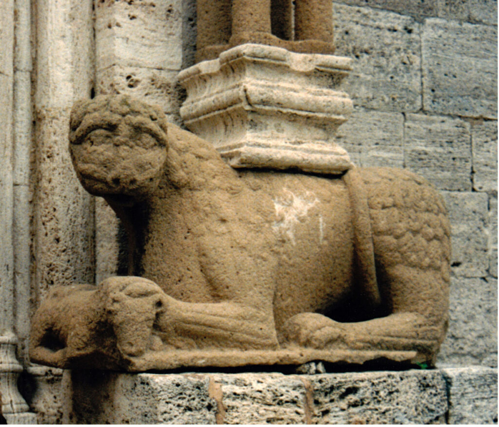 San Quirico d'Orcia (Siena), collegiate church, façade, lion with a lamb between its paws (12th century)